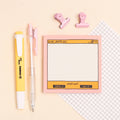 Notebook with digital interface design, pens, and clips on a light background