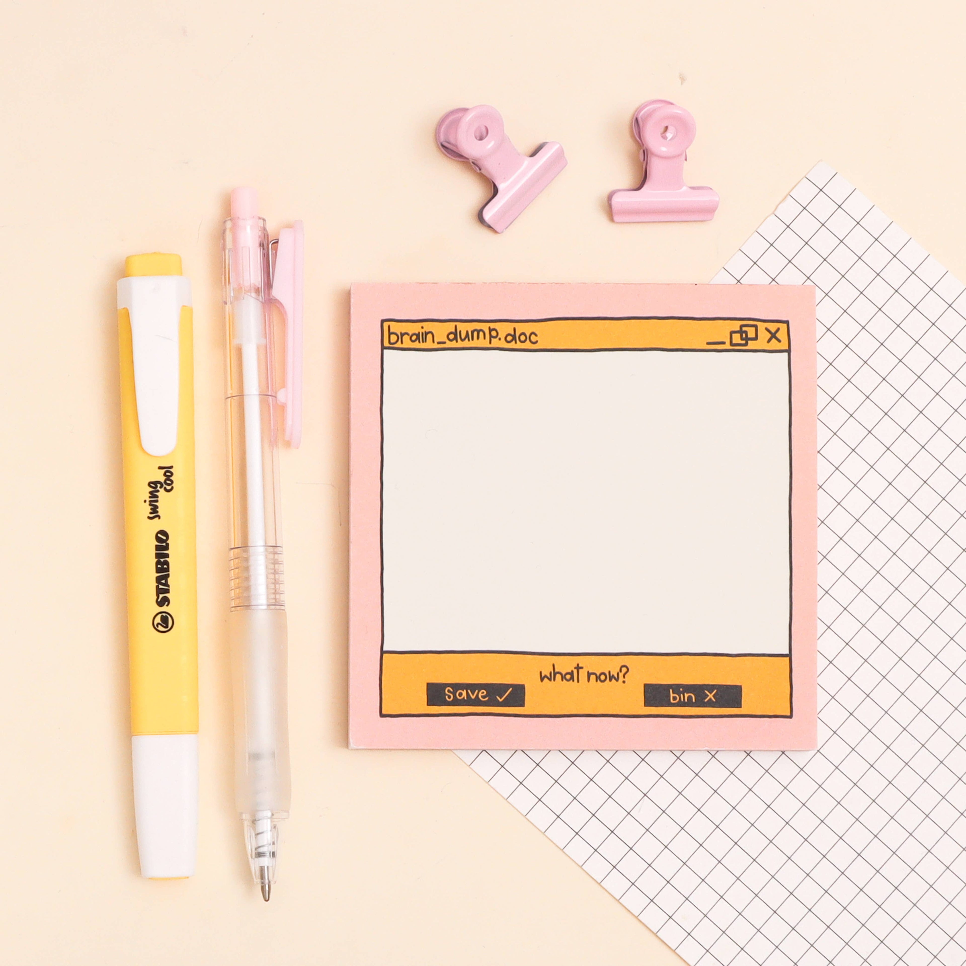 Notebook with digital interface design, pens, and clips on a light background
