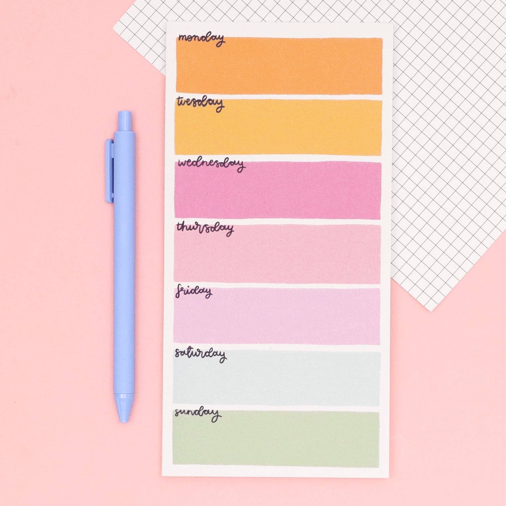 Weekly planner sticky notes with colorful days of the week labels on a pink background