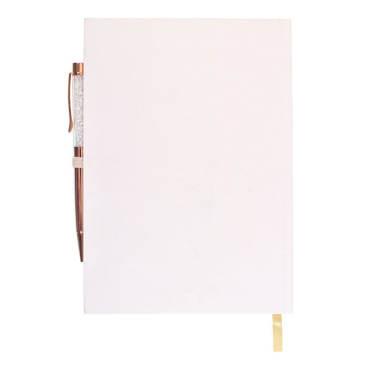 White notebook with a decorative pen on a white background