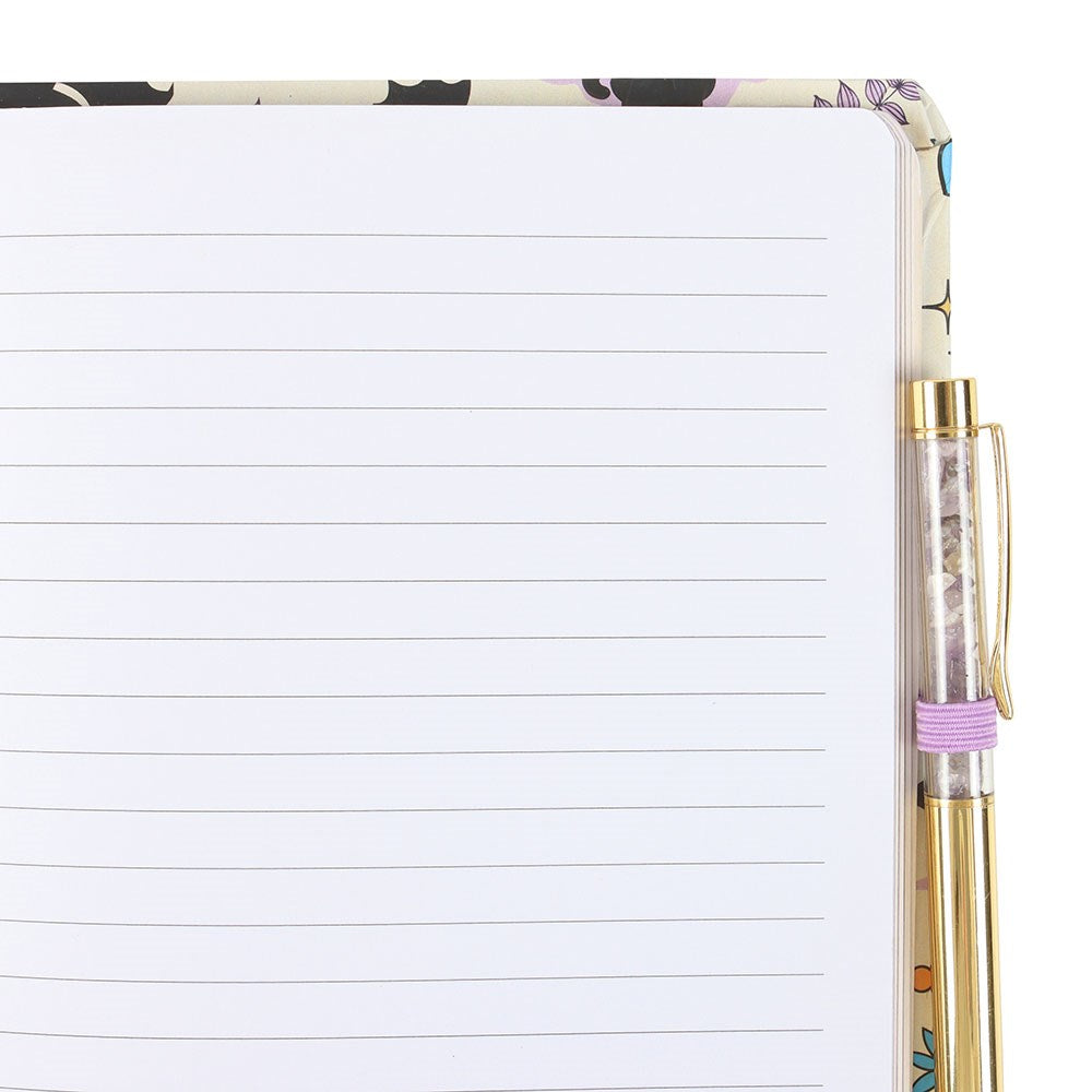 Notebook with black cat design on the cover and a gold pen.