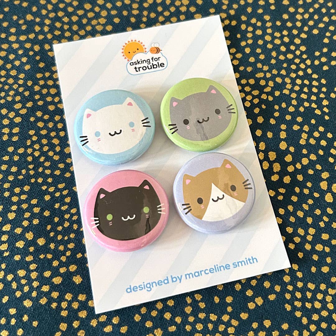 4 cat badges packaged on a backing card