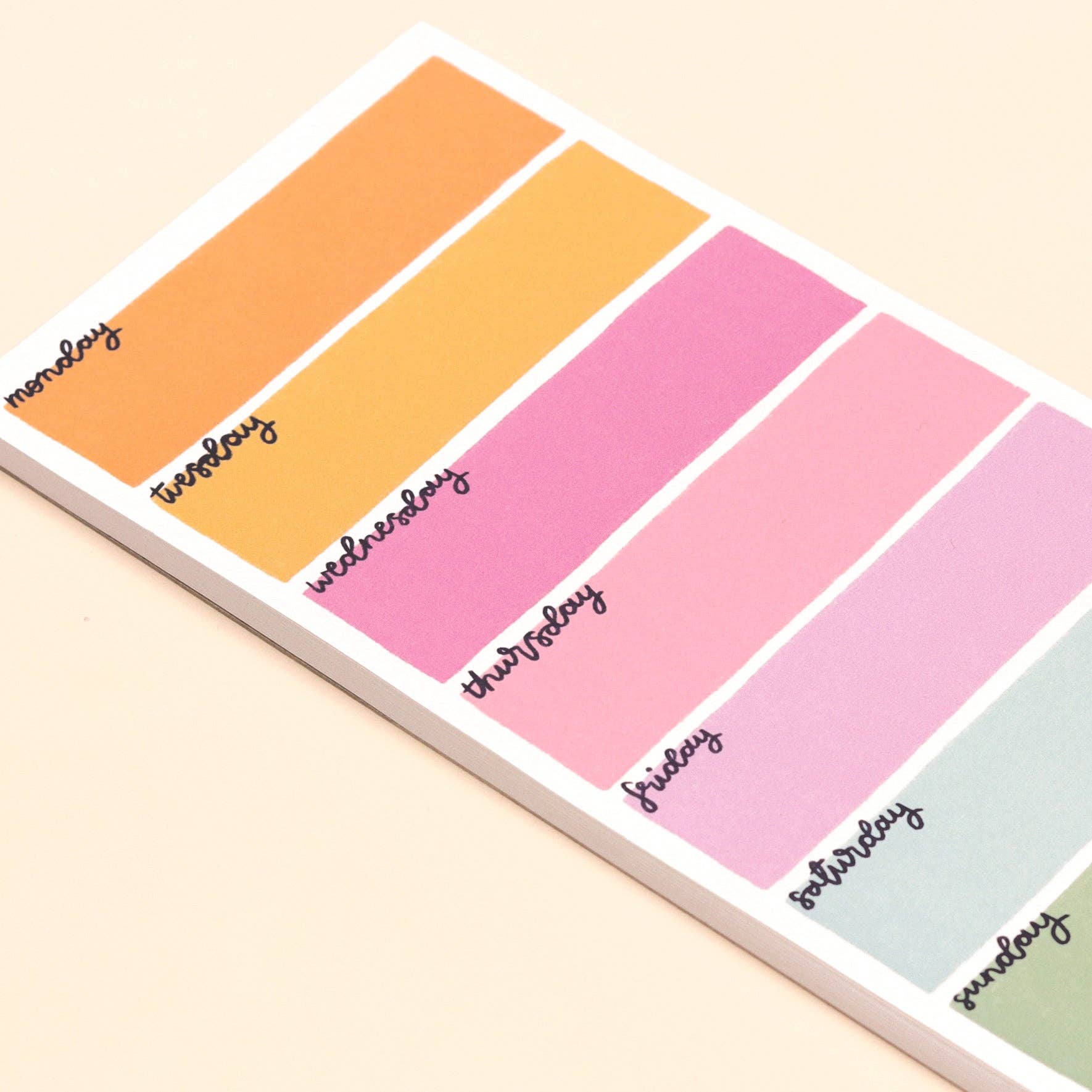 Colorful weekly planner with days of the week labels on a beige background
